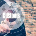 A businessman selecting a Customs Concept button on a clear screen.