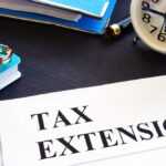 Tax extension. Folder with documents and clock.